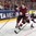 COLOGNE, GERMANY - MAY 13: Latvia's Andris Dzerins #25 plays the puck while fending off USA's Dylan Larkin #21 during preliminary round action at the 2017 IIHF Ice Hockey World Championship. (Photo by Andre Ringuette/HHOF-IIHF Images)

